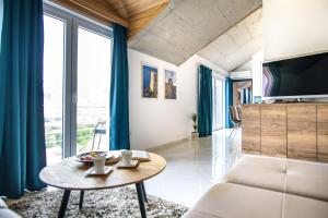 a living room with a table and a large window at California Apartments 3 in Dubrovnik