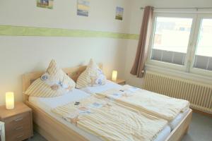 Postel nebo postele na pokoji v ubytování Appartment Vermietung Lütje