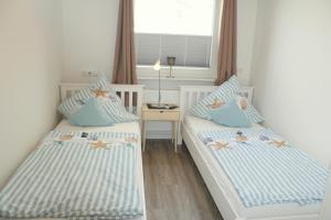 Postel nebo postele na pokoji v ubytování Appartment Vermietung Lütje