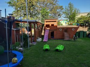 a childrens playground with a wooden play house at Apartament "u Mamy" Władysławowo in Władysławowo