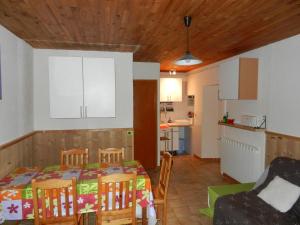 a kitchen and a dining room with a table and chairs at Gîte ROSIDAJEAN in Gresse-en-Vercors