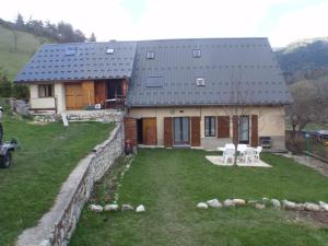 a house with a large yard in front of it at Gîte ROSIDAJEAN in Gresse-en-Vercors