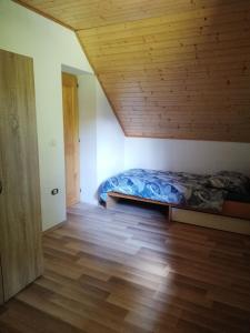 a bedroom with a bed and a wooden ceiling at Guest House Nanos in Vipava