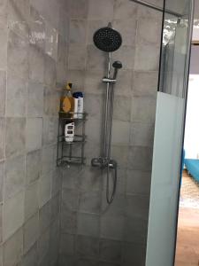 a shower in a bathroom with a glass door at Chalet adosado playa de La Barrosa in Chiclana de la Frontera