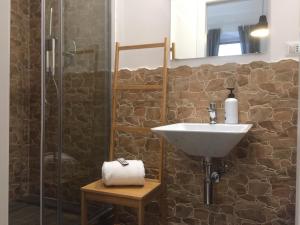 a bathroom with a sink and a shower at SmooRoomS Ostiense in Rome