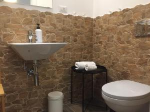 a bathroom with a toilet and a sink at SmooRoomS Ostiense in Rome