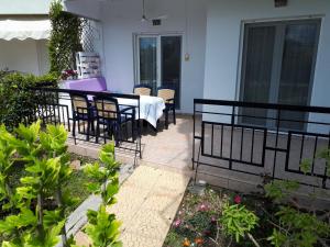 a patio with a table and chairs on a balcony at Iraklitsa bay apartment in Iraklitsa +5 photos