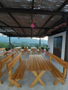 a group of picnic tables and benches on a roof at bed & breakfast Local Living Edi in Berat
