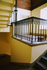 a stairway with a black railing and a window at Parva Villa in Miskolc