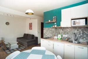 a kitchen with a table and a couch in a room at Chikma Apartments in Sarajevo