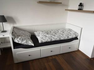 a bed in a room with a white bed frame at Krásný byt v centru Děčína in Děčín