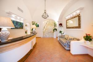 a living room with a couch and a staircase at Hotel Royal Prisco in Positano