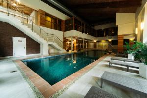 a swimming pool in a building with a staircase at SPA Hotel Veranda in Smolensk