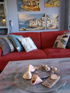 a living room with a red couch and a glass table at villa Grace,10p,seaview,pool in Calpe