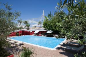 a swimming pool with a bridge in the background at Duparc Hotel in Gabicce Mare