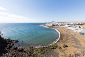 a view of a beach with buildings and the ocean at Near Airport Comfy Stay Gran Canaria in Playa del Burrero