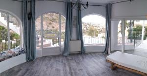 a room with arched windows and a bed and a balcony at villa Grace,10p,seaview,pool in Calpe +45 photos