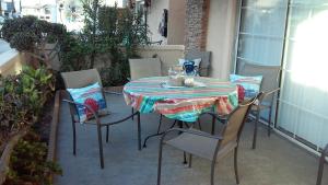 a table and chairs sitting on a balcony with a table and chairs at 25 Steps to the Beach in Newport Beach +46 photos