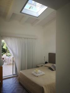 a bedroom with a bed and a skylight at Green House Beach in Mondello
