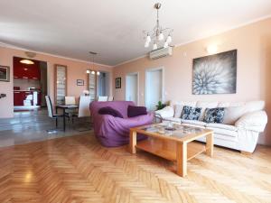 a living room with a couch and a table at Apartments La Perla in Mlini