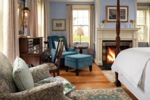 a bedroom with a bed and a fireplace at Candleberry Inn on Cape Cod in Brewster