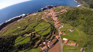 an aerial view of a village on a hill next to the ocean at Pandora in Faja Grande