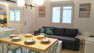 a living room with a table and a couch at Kaixo Family in Zarautz