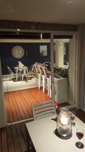a balcony with a table and chairs on a boat at Sea Breez in St Francis Bay