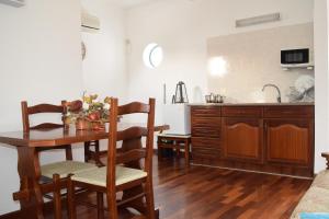 a kitchen with a table and chairs and a dining room at MemSoares Country House in Castelo de Vide