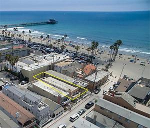 an aerial view of a beach with a parking lot at 25 Steps to the Beach in Newport Beach