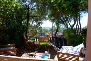 a patio with a table and chairs with a view at Villa Bianca in Capitana