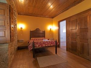 a bedroom with a bed and a wooden ceiling at Quinta da Casa Alta in Valença +69 photos