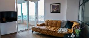 a leather couch in a living room with glass windows at Urban 35 in Chania Town