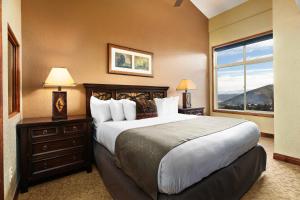 a bedroom with a large bed and a window at Condos at Canyons Resort by White Pines in Park City +154 photos