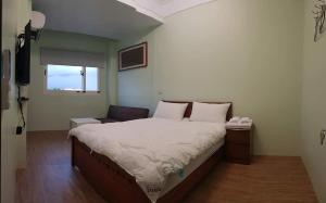 En eller flere senger på et rom på JiuZhiAn Apartment