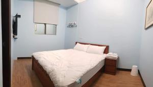 En eller flere senger på et rom på JiuZhiAn Apartment