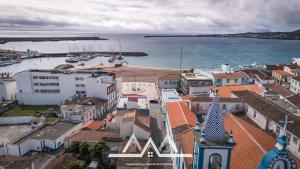 an aerial view of a town with the ocean at White House I in Praia da Vitória