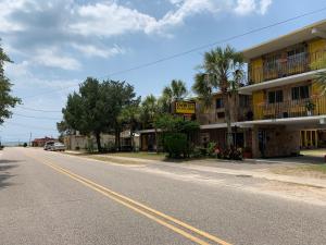 an empty street in front of a hotel at DeWitt Rooms & Cottages in Myrtle Beach