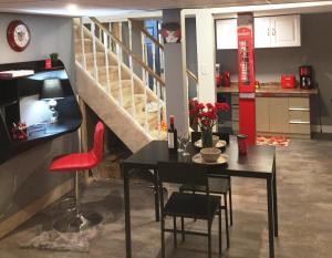 a dining room with a table and a staircase at Gracies Fallsview Getaway in Niagara Falls