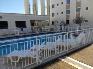 a balcony with chairs and a swimming pool at Apto térreo com área privativa ! in Rio das Ostras