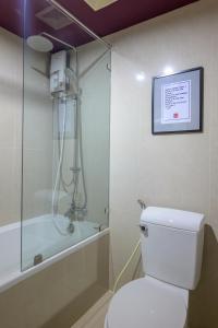 a bathroom with a shower and a toilet and a bath tub at Quarter 09 Beach in Jomtien Beach