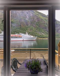 a cruise ship in the water from a window at Solhaug Fjordcamping in Geiranger