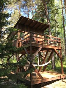a tree house in the middle of a forest at Tahkuna tree-house in Malvaste