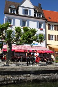 a group of people sitting in front of a restaurant at Schützen Hotel Meersburg Bed & Breakfast in Meersburg +15 photos