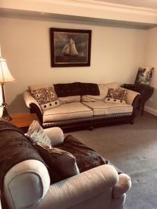 a living room with two couches and a couch at Niagara Mansion Carriage Suite in Lewiston