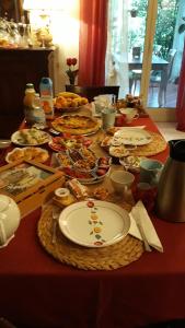 a table with plates of food on top of it at La Corte delle Rose B&B in Praia a Mare