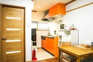 a small kitchen with a table and a refrigerator at HAKU Wamikyo in Kyoto