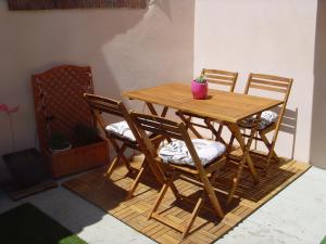 a wooden table and chairs with a potted plant on it at Les Aubettes in Jumeaux