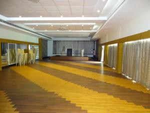 a hallway with a waiting room with yellow chairs at Nalla Eco Beach Resort in Pondicherry +40 photos