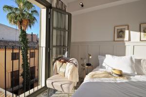 um quarto com uma cama e uma varanda em Hotel Basilica em Palma de Maiorca